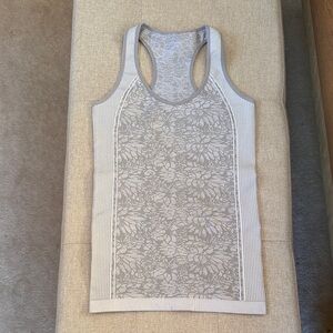 Fabletics Athletic Wear, Racerback Tank Top. Light gray floral pattern.